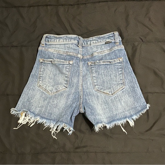 Risen high rise. Distressed jean shorts. - Picture 4 of 9